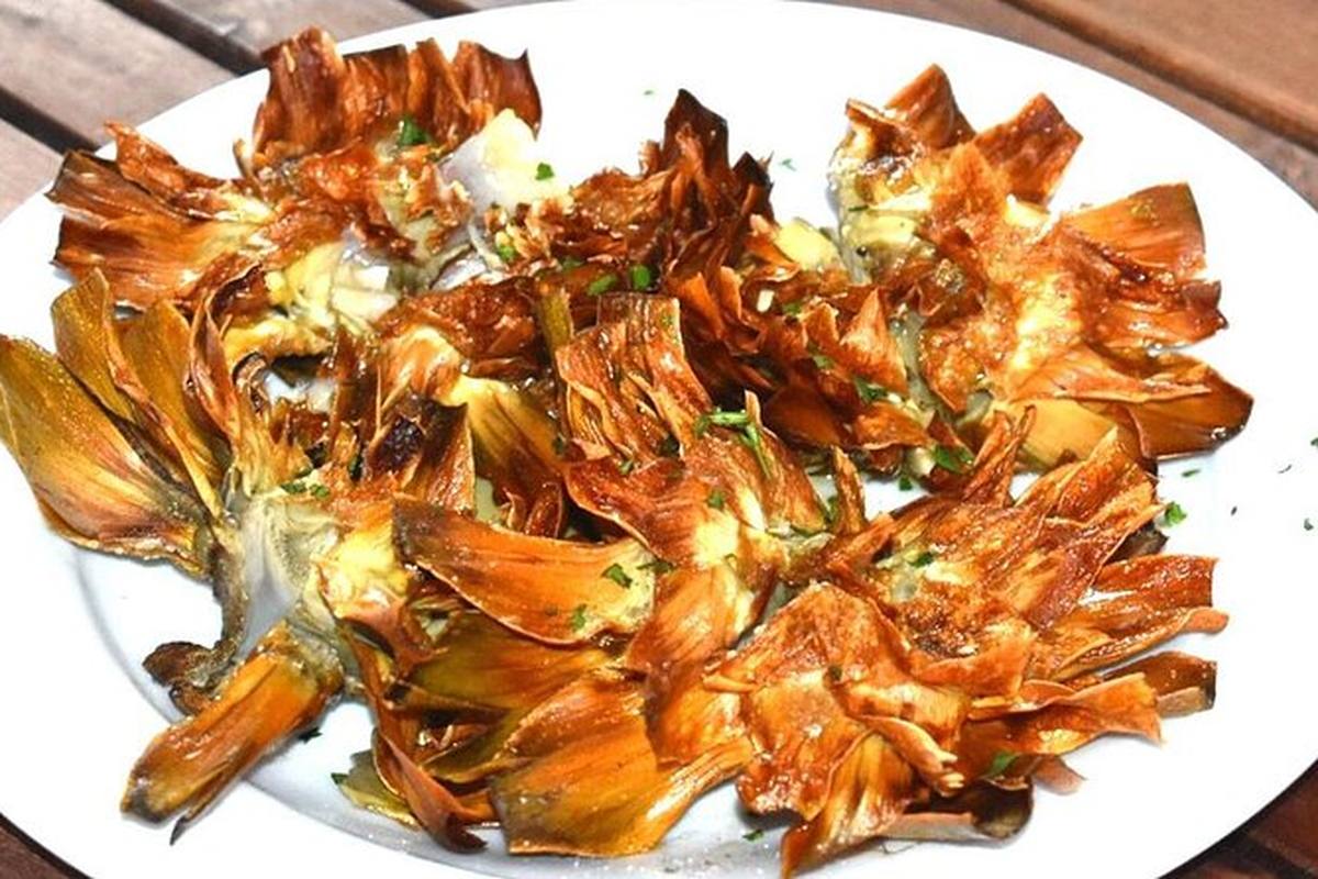 A plate of carciofi alla giudia, the artichokes pressed flat and fried whole in the Jewish Ghetto