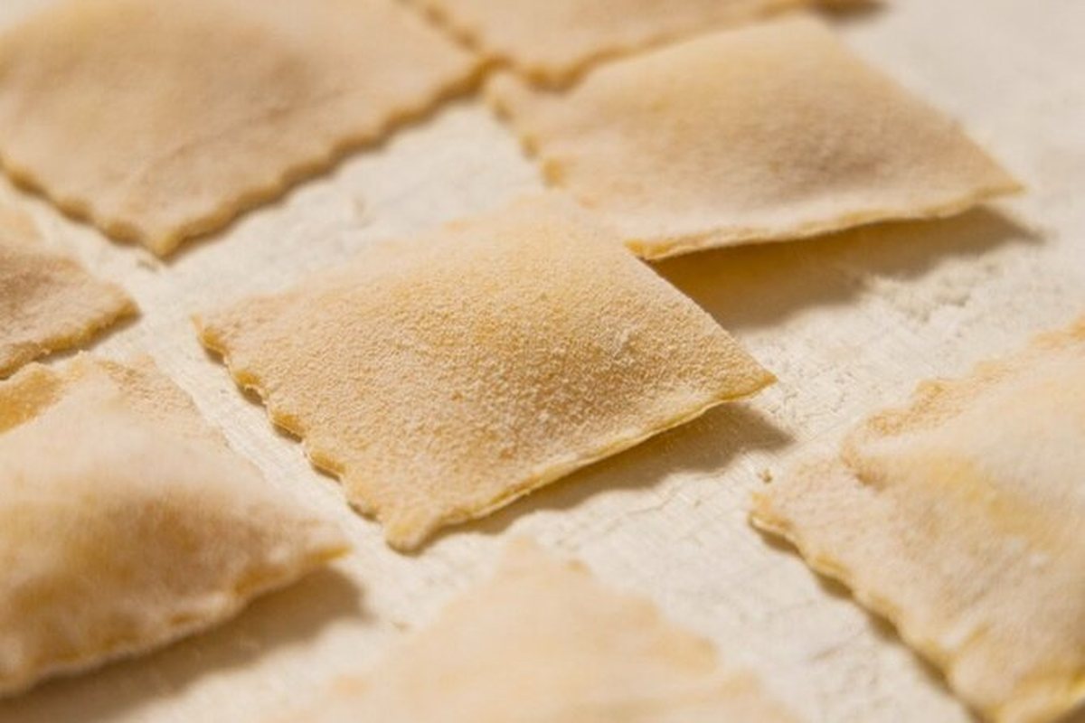 Rows of fresh ravioli on a floured board at a Rome cooking class