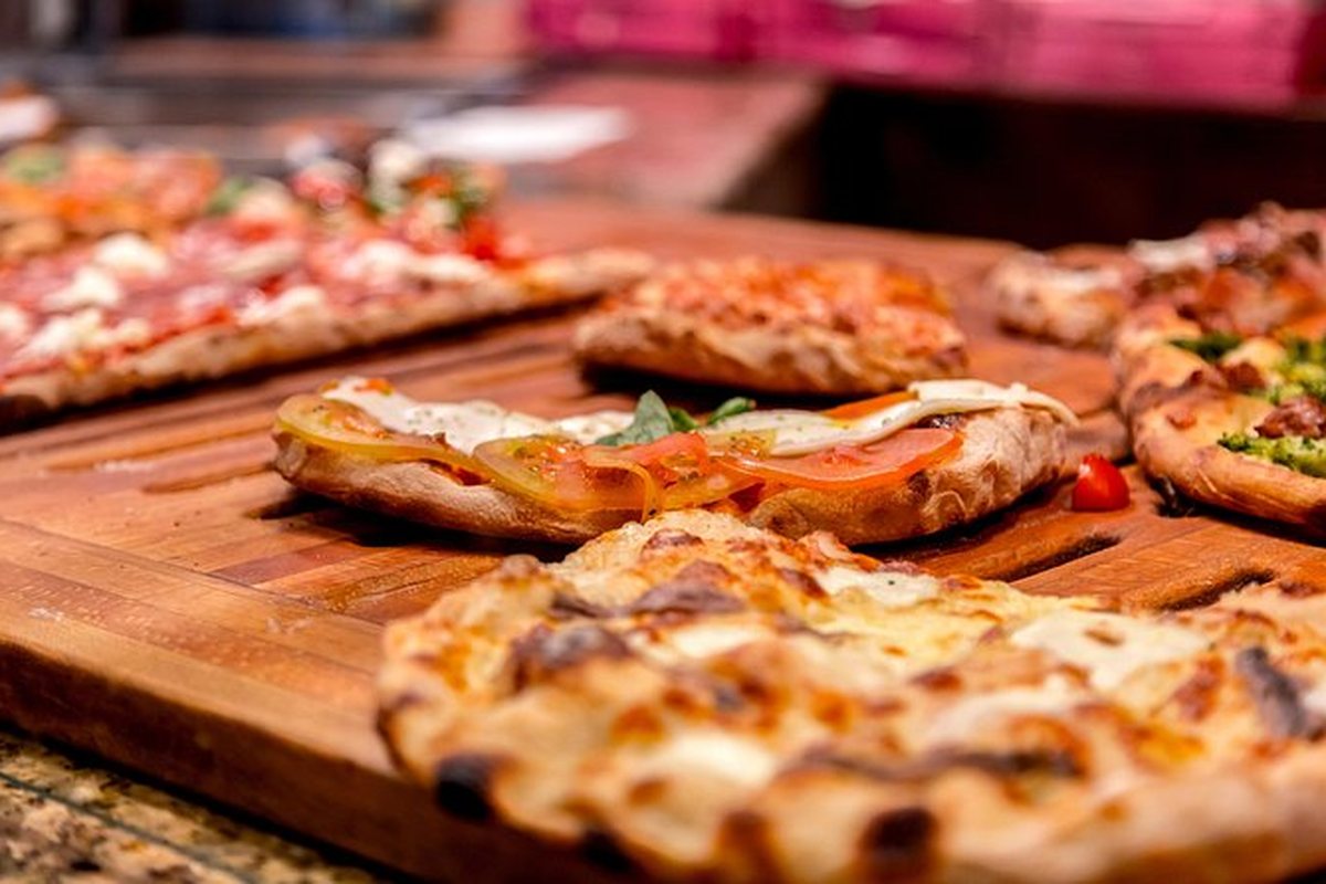 A tray of Roman pizza al taglio, cut into squares and sold by weight