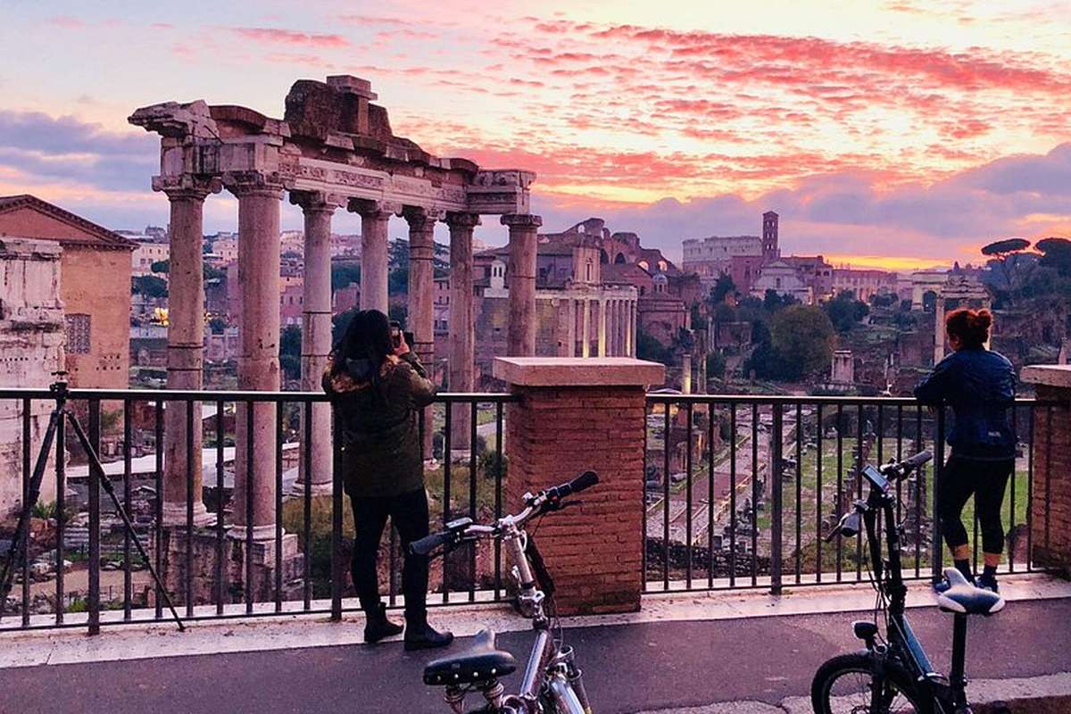 The columns of the Roman Forum against a pink sunset
