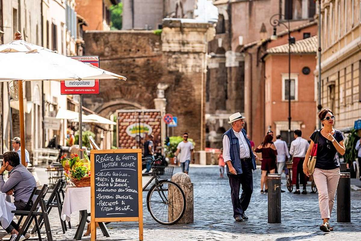 Pavement tables and a chalkboard menu on a Trastevere street